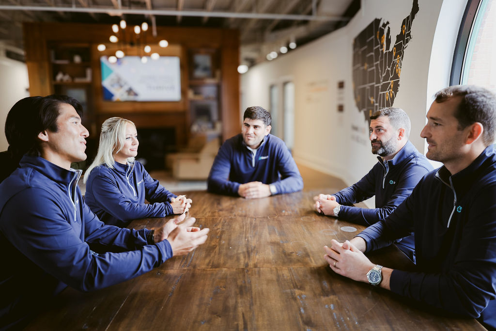 The Stem IT team gathered around a conference table