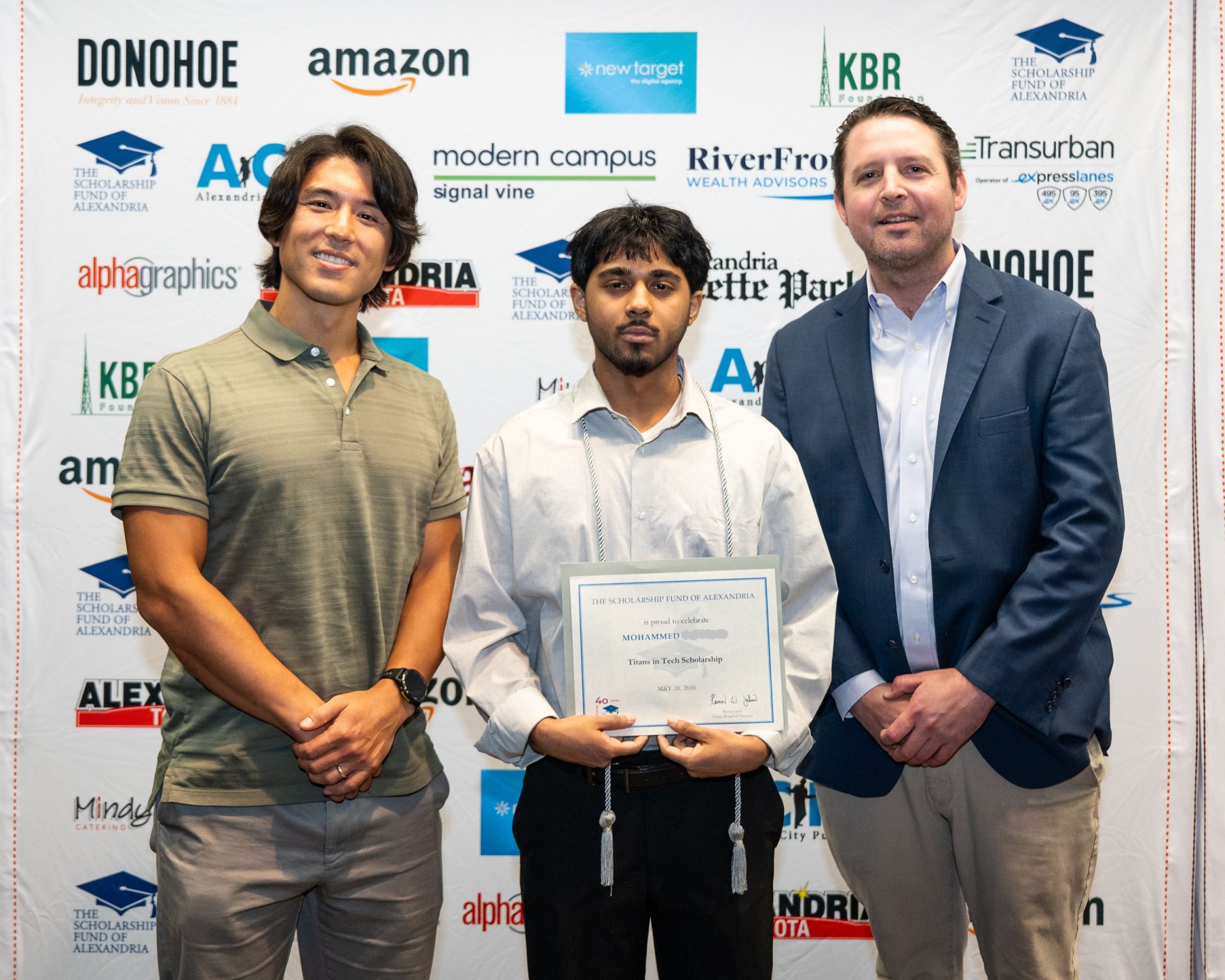 Three people at a Scholarship Fund of Alexandria event, with the center participant holding a Titans in Tech Scholarship certificate.